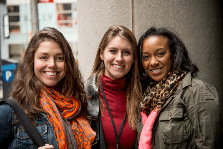 three-women-with-arms-aroundn-each-other-smiling